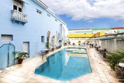 small pool surrounded by blue loungers