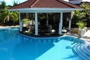 pool with bar surrounded by palm trees