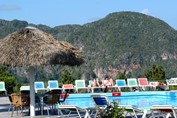 pool with loungers and mountains in the background