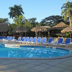 pool surrounded by blue sunbeds and umbrellas