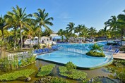 pool by the lagoon surrounded by palm trees