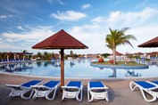piscina con tumbonas y sombrillas alrededor