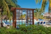 pool surrounded by sun loungers and guano umbrella