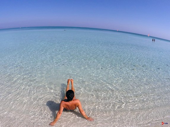 tourist on the beach with crystal clear waters