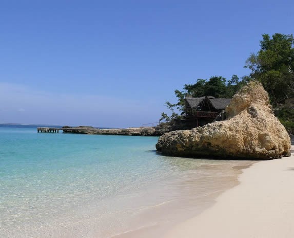 beach with transparent waters and large rocks