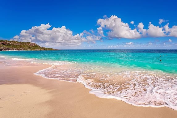 deserted beach of golden sands and blue sea