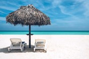 beach with sun beds and guano umbrellas