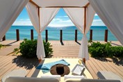 deck chair under umbrella with ocean view