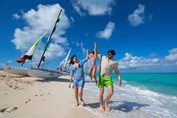 tourists walking on the beach on a sunny day