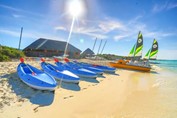 catamarans and kayaks on the shore of the beach