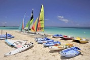 sailboats and kayaks on the sand