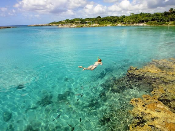 crystal clear waters and woman snorkeling