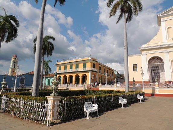 benches in colonial square with colorful buildings