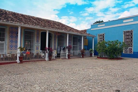 colonial house with tiles in cobblestone street