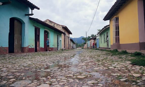 cobbled street surrounded by colorful houses