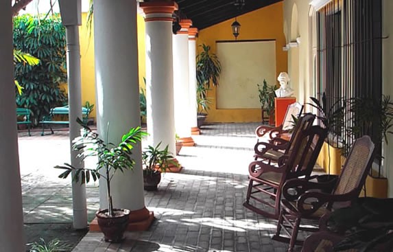 patio with wooden armchairs under roof