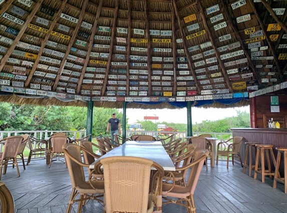 wooden bar and furniture under guano roof