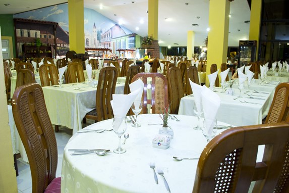 restaurant with wooden furniture and table linen