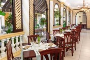 restaurant with wooden furniture and greenery