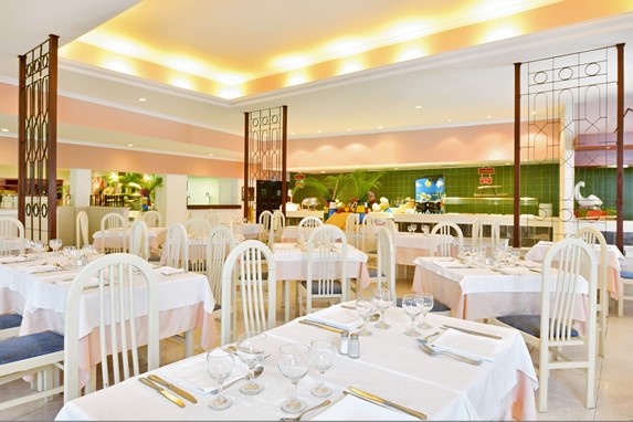 restaurant with white furniture and tablecloths