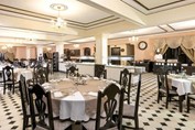 restaurant with wooden furniture and tablecloths