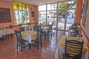 restaurant with furniture and decorative paintings