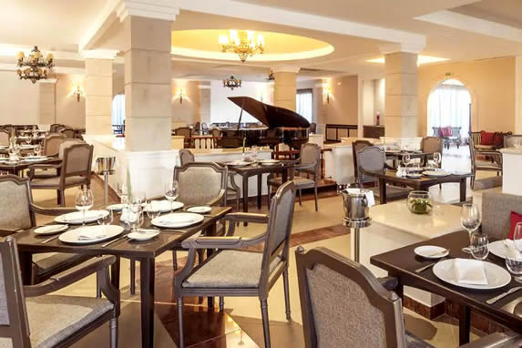 restaurant with wooden furniture and piano