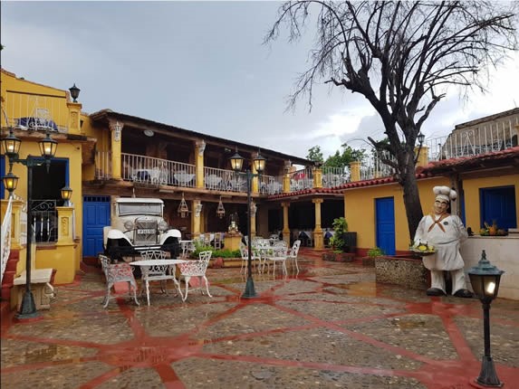 patio with iron furniture and old car