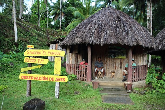 cabin with guano roof and rustic sign