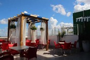 terrace with pergola and red and white furniture