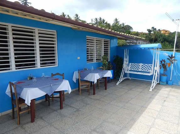 terrace with wooden furniture and tablecloths