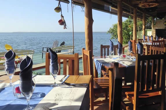 terrace with sea view and wooden furniture