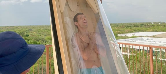 Tourist going down a slide in the park