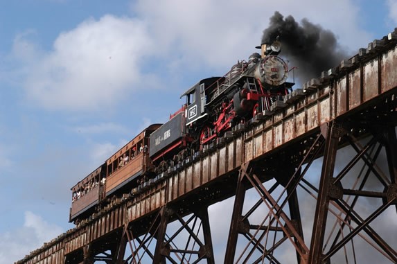 old steam train over iron bridge
