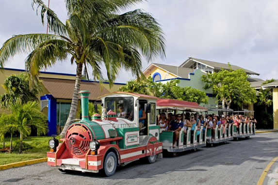 small train with tourists at the hotel entrance