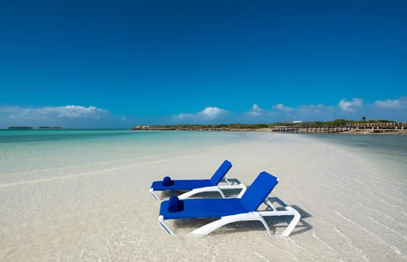 beach with deckchairs and clear waters