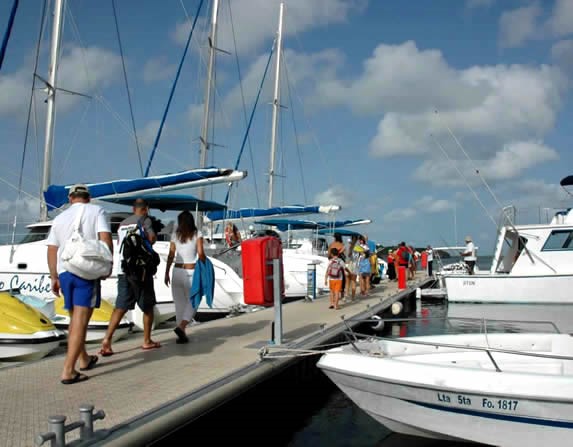 tourists on the dock on the way to a boat