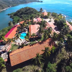 aerial view of the hotel surrounded by sea