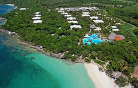 aerial view of the hotel by the sea with greenery