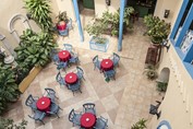 courtyard with blue chairs and tables