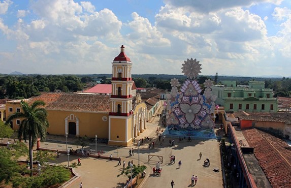 aerial view of a square with a yellow church