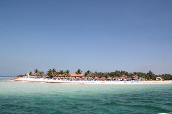 view of the shore of white sand and blue waters