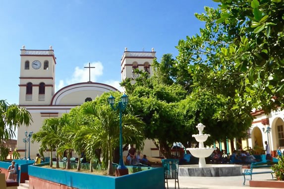 park surrounded by colonial buildings and plants